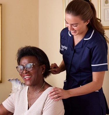 Care Expert brushing female customers hair