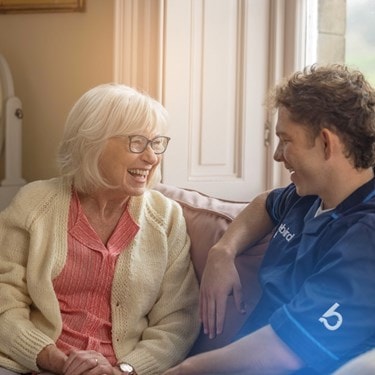 female customer and male carer on sofa