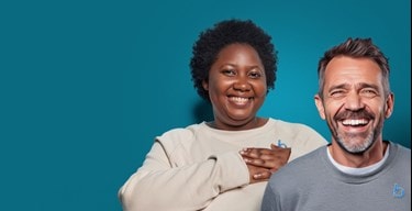 Bluebird Care employees smiling on a teal background