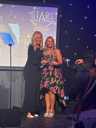 Sophie being presented with Home Care Manager Award by Josie Gibson