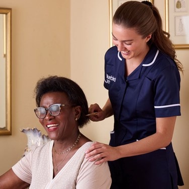Care Expert brushing female customers hair