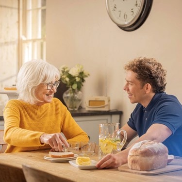 female customer and carer having breakfast at home
