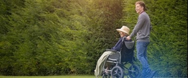 Carer with an lady in a wheelchair