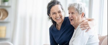 A carer chatting and smiling with an elderly customer