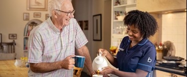 Tea and chat in the kitchen with a carer and an elderly man