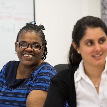 Two smiling female office workers
