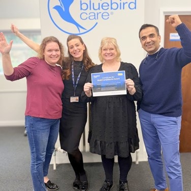 celebrating Gold Compliance Award with 97 percent audit score