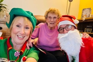 Elf and Santa visiting a customer