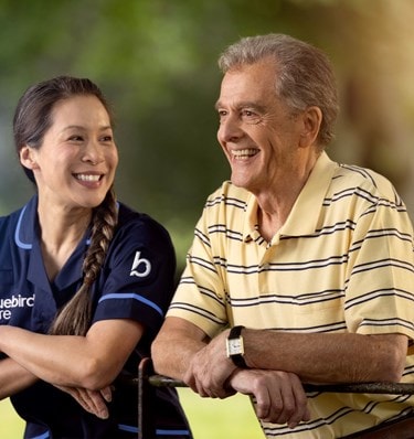 care expert and male customer leaning on fence