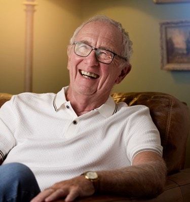 happy male customer sitting in a chair