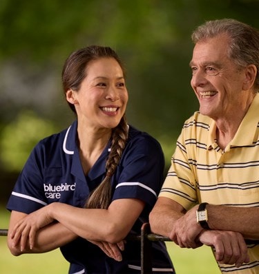 Care Expert and male customer leaning on fence