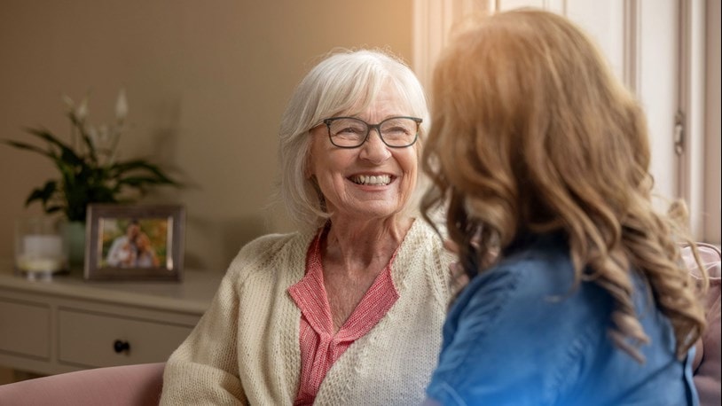 carer chatting to an elderly lady at home