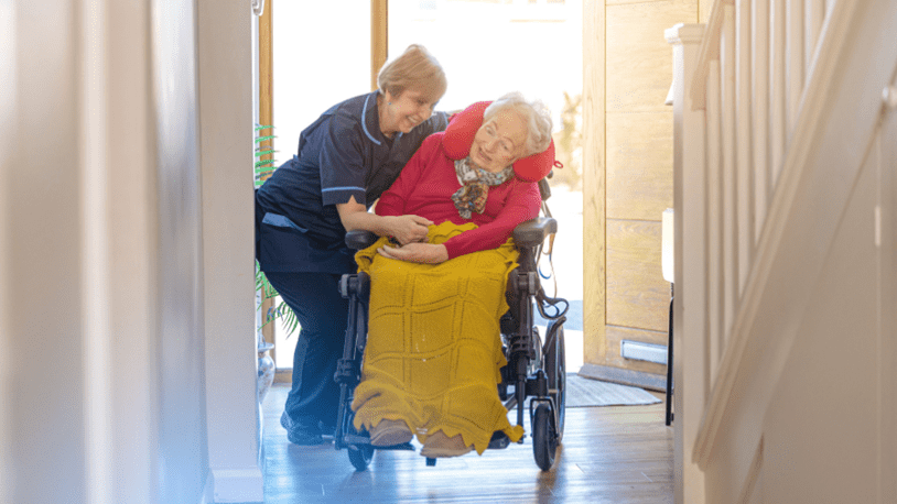 Care expert helping customer in wheelchair
