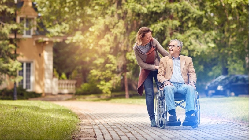 Outside with a lady and a dementia patient in a wheel chair