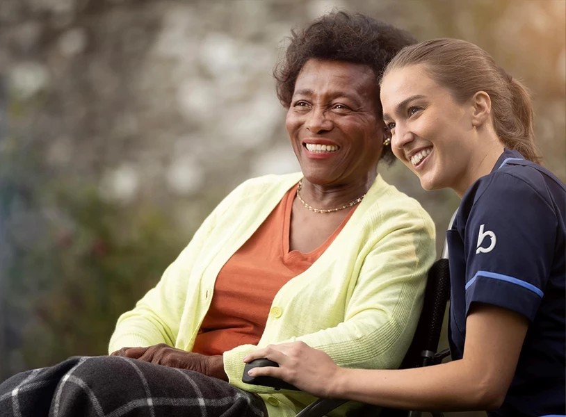 Bluebird Care live-in carer with an elderly patient smiling