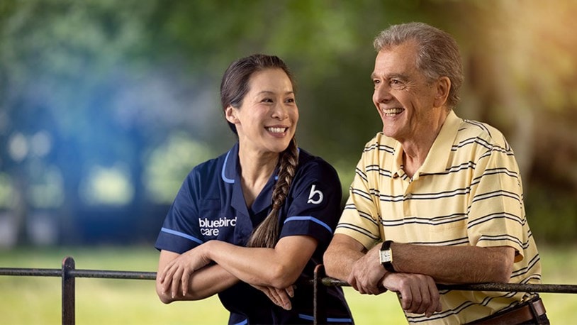 care expert and male customer leaning on fence