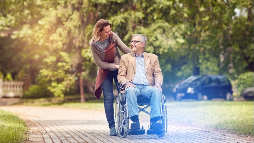 Carer with an elderly man in a wheelchair