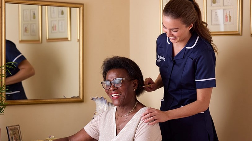 Care Expert brushing female customers hair