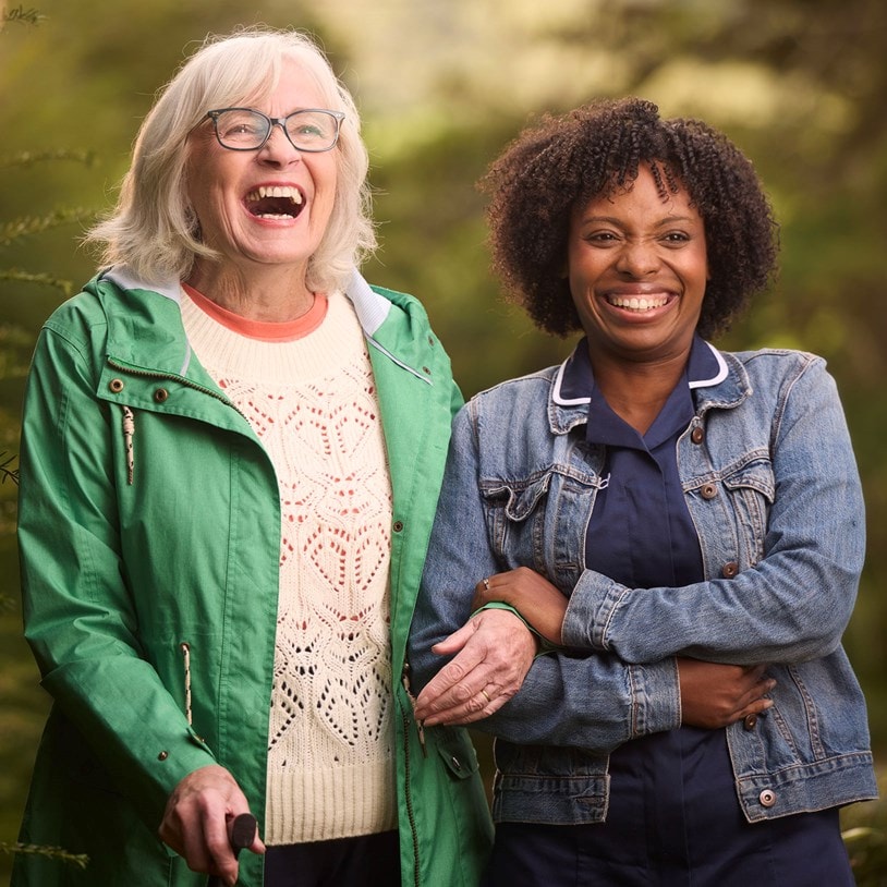 Care Expert and female customer walking outside