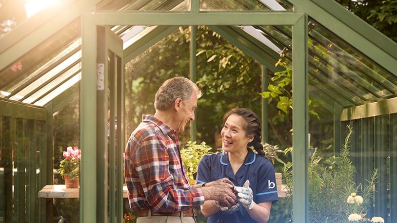 male customer and carer in greenhouse