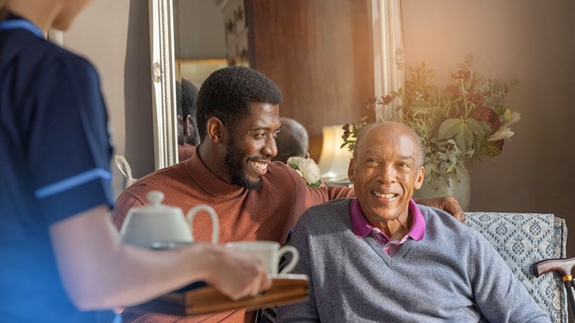 male customer and relative sat on sofa