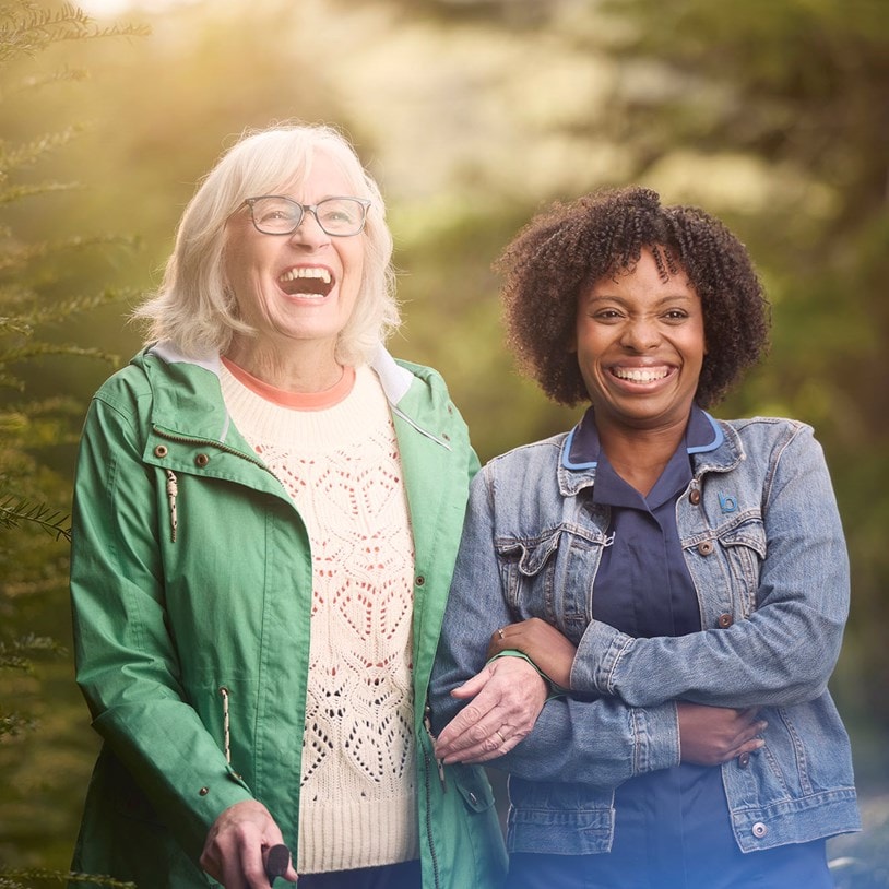 female customer and carer laughing in garden