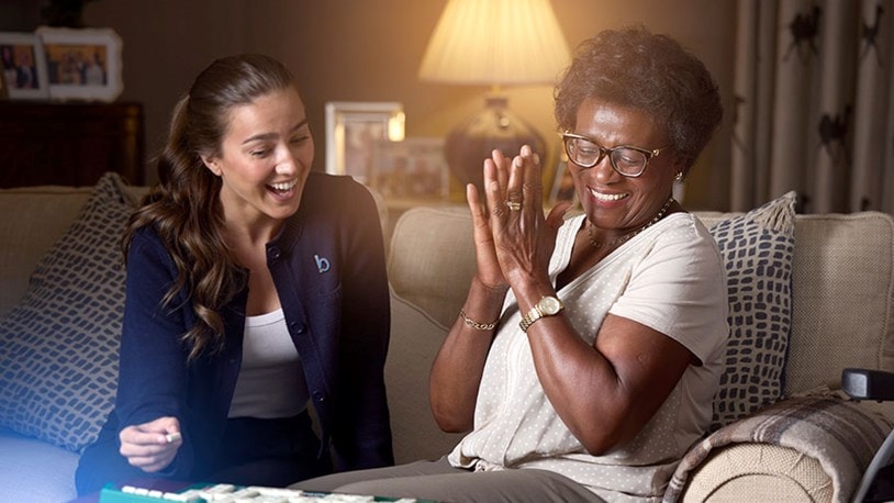 care expert and female customer playing scrabble
