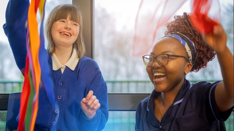 A girl and a carer with ribbons