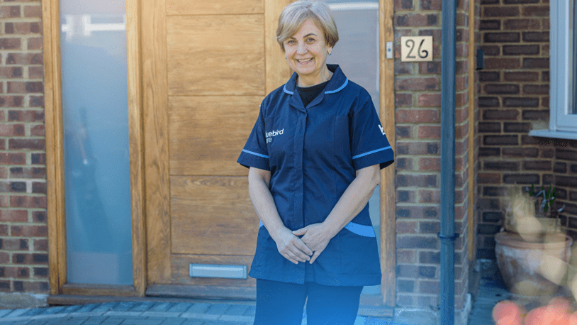 Carer in front of a customers home