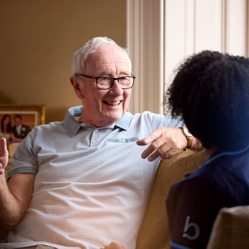 male customer and female carer on sofa