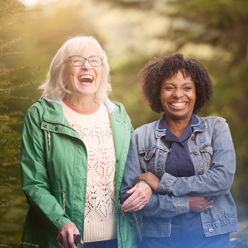 female customer and carer laughing in garden