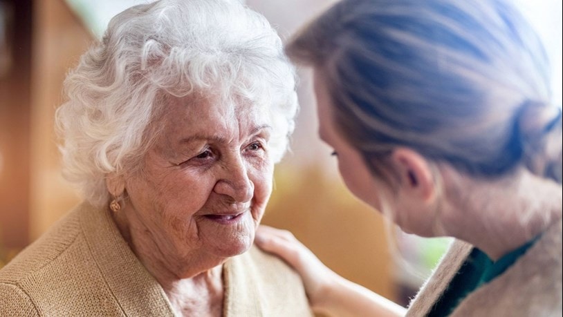 Elderly lady chatting to a family member at home