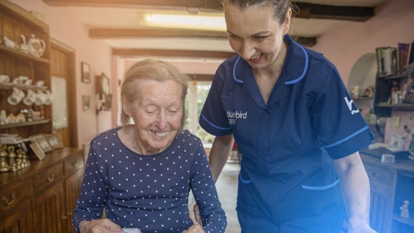 Carer assisting a elderly patient in the home