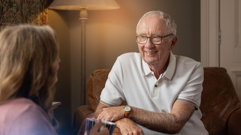 Elderly lady chatting to a family member at home