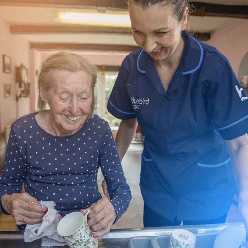 female customer and carer washing up in the sink