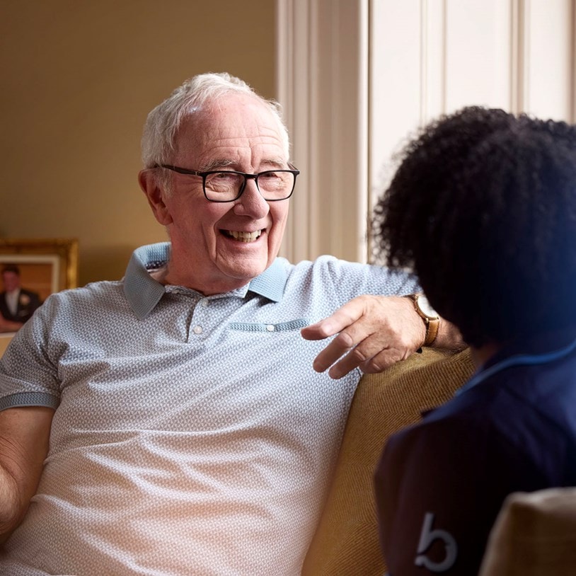 male customer and female carer on sofa