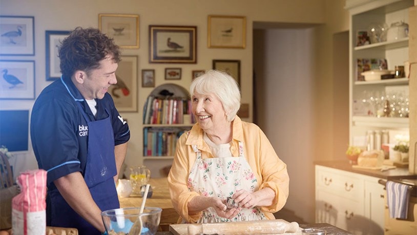 female customer and carer baking in kitchen