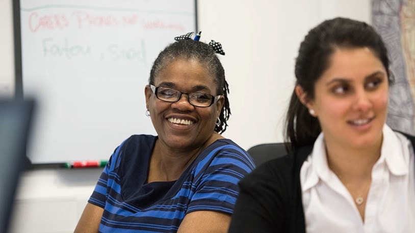 Two smiling female office workers
