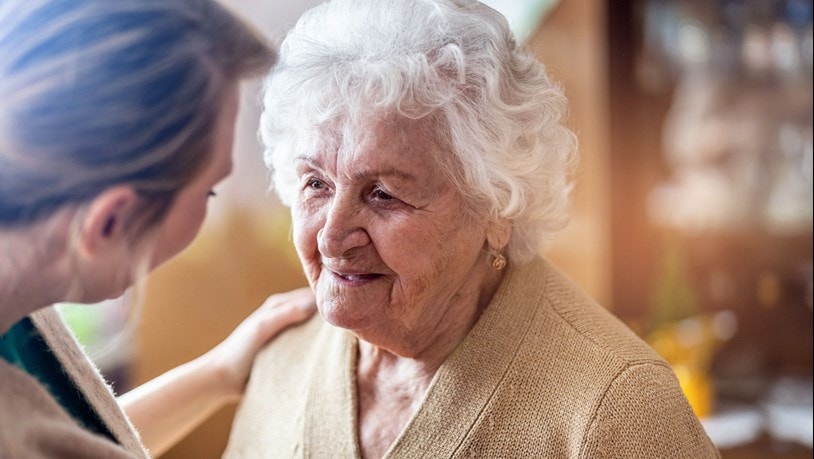 Elderly lady being cared for by a carer