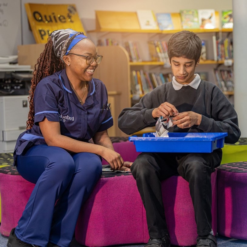 Bluebird Care Care Expert helping a pupil.