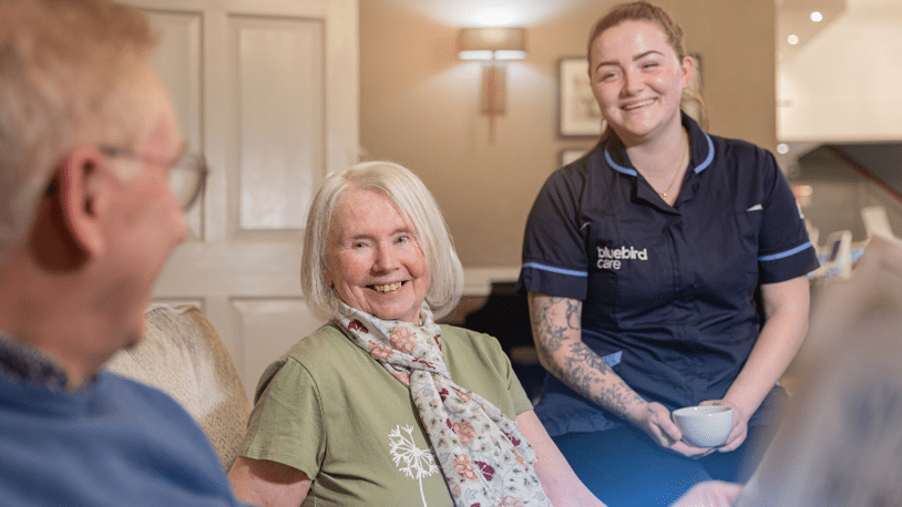 A couple at home chatting to their carer