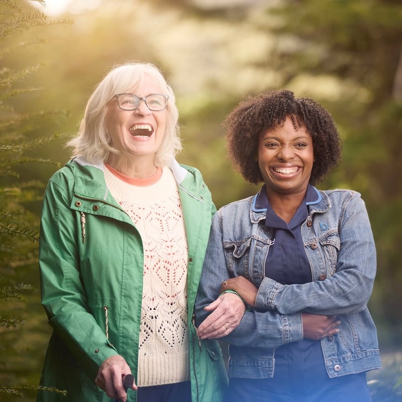 female customer and carer laughing in garden
