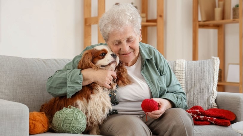 elderly lady hugging her pet dog