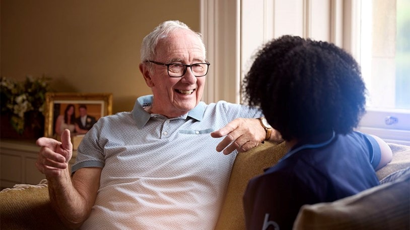 male customer and female carer on sofa
