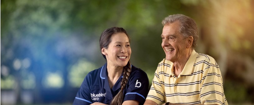 care expert and male customer leaning on fence