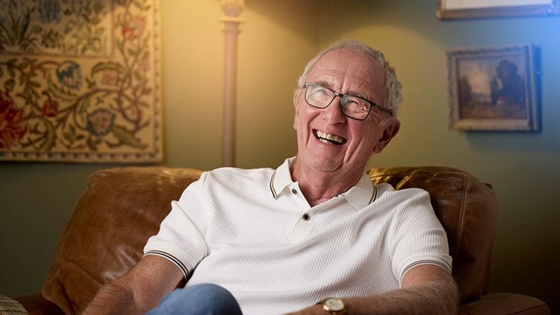 happy male customer sitting in a chair