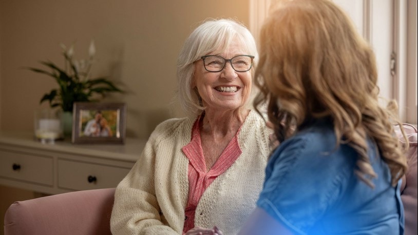 Elderly lady having a chat with a carer