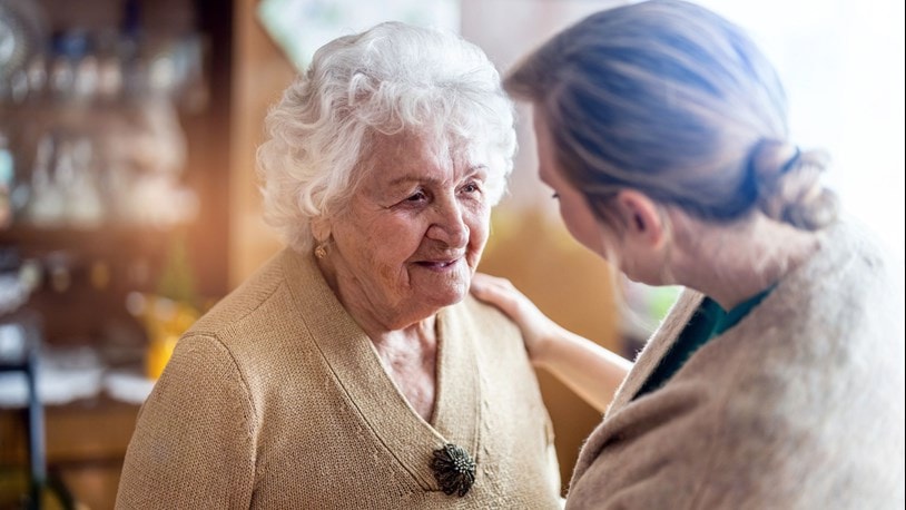 Elderly lady chatting to a family member at home